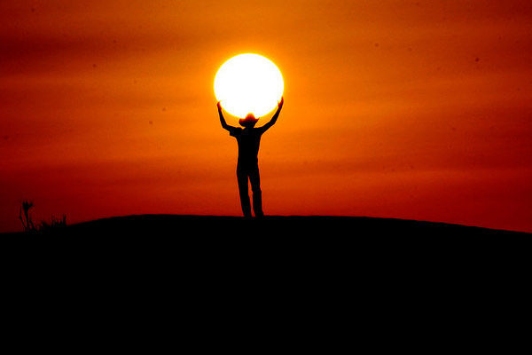 178708-Man-Holding-The-Sun-During-Sunset